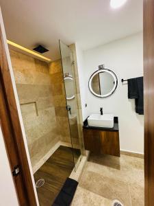 a bathroom with a sink and a mirror at Naia Tulum Apartment in Tulum