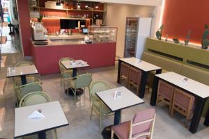 a restaurant with tables and chairs and a counter at Hotel Residencial España in Salta