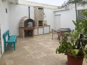a patio with a pizza oven and a table and chairs at Casa Bella Suit in Salinas