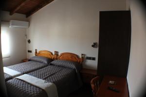 Postel nebo postele na pokoji v ubytování Hostal Extremeño