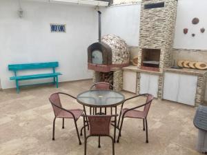 a table and chairs in a room with a pizza oven at Casa Bella Suit in Salinas