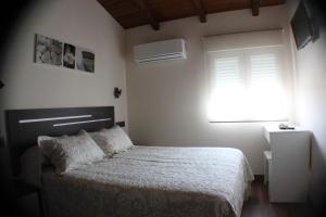 Postel nebo postele na pokoji v ubytování Hostal Extremeño