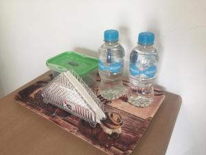 a tray with two bottles of water on a table at Casa Bella Salinas in Salinas +10 photos