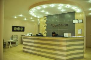 a woman sitting at a reception counter in a store at Nevada Hotel & Spa in Fethiye