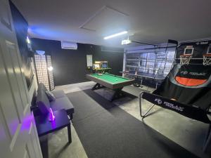a room with a pool table and a ping pong ball at Resort Community 4 Bedroom Family Home, Pool & 15 Min Disney in Kissimmee