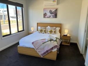 a bedroom with a large bed and a window at Seaside Retreat, St Leonards in Saint Leonards