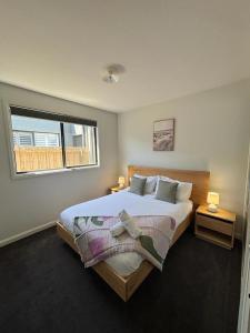 a bedroom with a large bed and a window at Seaside Retreat, St Leonards in Saint Leonards