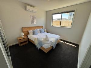 a bedroom with a large bed with a window at Seaside Retreat, St Leonards in Saint Leonards
