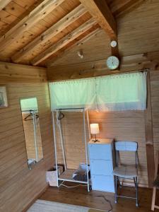 a room with a bed and a clock on the ceiling at Minpaku Yururi in Yakushima
