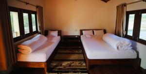 Postel nebo postele na pokoji v ubytování Bardia Eco Friendly Homestay