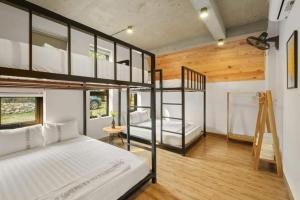 a bedroom with two bunk beds and a ladder at LaLa Villas in Hòa Bình