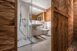 a bathroom with a shower and a toilet at Arosa Vetter Hotel in Arosa