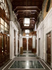 a hallway of a building with a pool in the middle at Casa Cipriani Milano in Milan +49 photos