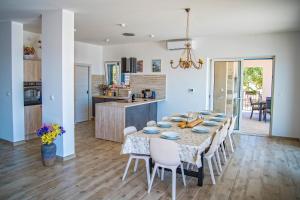 a dining room and kitchen with a table and chairs at Villa J&J in Kastel Novi +49 photos