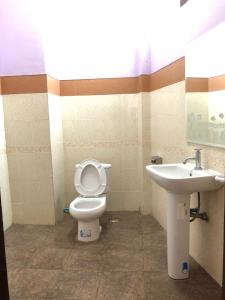 a bathroom with a toilet and a sink at Soutjai Guesthouse & Restaurant in Vang Vieng +8 photos
