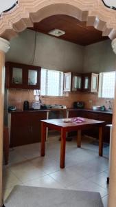 a kitchen with a table in the middle of it at Hotel Titanic in Basdiot +21 photos