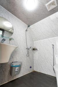 a bathroom with a shower and a toilet at The Melody Mộc Châu in Mộc Châu
