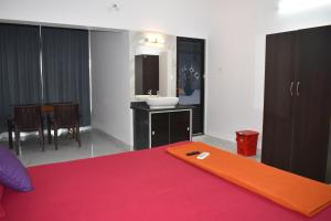 a bedroom with a bed with an orange board on it at GUNDAPPA cafe GOKARNA KUDLE beach in Gokarn
