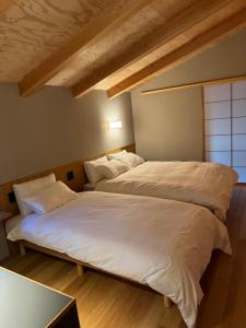 Postel nebo postele na pokoji v ubytování 出雲の貸別荘 まちとけ大社