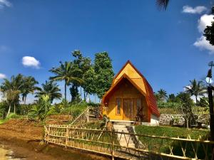 a small house with a fence in front of it at Eger Rise Terrace Bungalow in Kotaraja