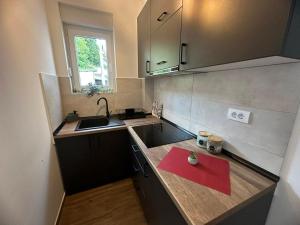 a small kitchen with a red napkin on a counter at Apartman Pavlović in Soko Banja