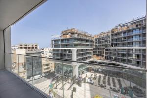 a view of a building under construction from a window at Piazza Panorama In The Island's Tallest Landmark in St Julian's