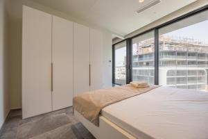 a bedroom with a bed and a large window at Piazza Panorama In The Island's Tallest Landmark in St Julian's +34 photos