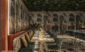 a long dining room with a long table and chairs at Piazza Panorama In The Island's Tallest Landmark in St Julian's