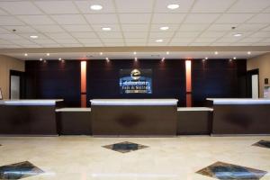 a waiting room with a sign on the wall at Clarion Inn & Suites Miami International Airport in Miami