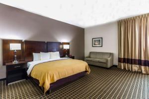 a hotel room with a bed and a couch at Clarion Inn & Suites Miami International Airport in Miami