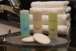 a tray with three candles on top of a sink at Clarion Inn & Suites Miami International Airport in Miami