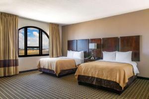 a hotel room with two beds and a window at Clarion Inn & Suites Miami International Airport in Miami +35 photos
