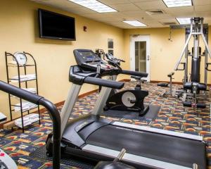 a gym with a treadmill and a flat screen tv at Clarion Inn & Suites Miami International Airport in Miami