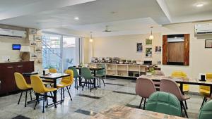 a restaurant with tables and chairs and a counter at Perch Arbor Cyber City in Gurgaon