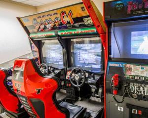 a video game machine with a guitar on it at Clarion Inn & Suites Miami International Airport in Miami