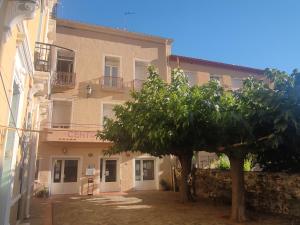 a building with a tree in front of it at Central Hôtel in Cerbère