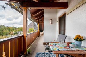balcón con mesa y vistas al patio en Ferienwohnung Breitenberger, en Herrsching am Ammersee