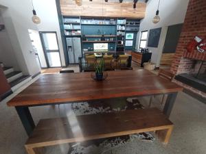 a large wooden table in a room with a couch at Jbay Holiday Home in Jeffreys Bay