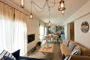 a living room with a couch and a table at Yades Villas in Athanion