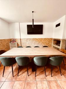 a large wooden table and chairs in a room at La Puerta de Viana, con garaje y txoko! in Viana +17 photos
