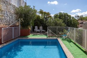 a small swimming pool with a gate and a fence at Villa Florita in Valdelaguna