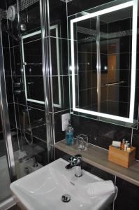 a bathroom with a sink and a mirror at Westgate Apartments Birchlee in Inverurie