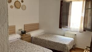 a room with two beds and a window at Apartamento El Cortijo in Mojácar