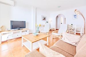 a living room with a couch and a table at Strand Appartement Met Zwembad Td04 in Torrox