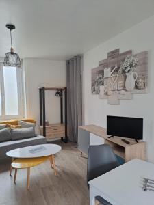 a living room with a couch and a table at Studio Dinard in Dinard