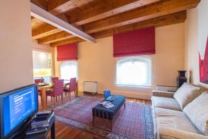 sala de estar con sofá y TV en Residenza Giudecca Molino Stucky, en Venecia