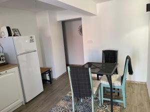 a kitchen with a table and chairs and a refrigerator at Guest House Malusha in Gabrovo