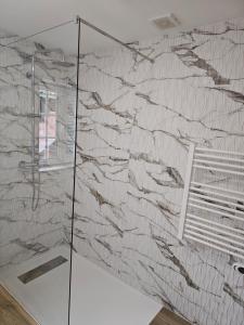a bathroom with a wall covered in marble at Destro village in Lindoso +22 photos