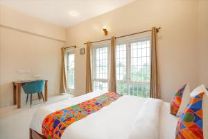 Postel nebo postele na pokoji v ubytování Bougainvillea Suites