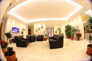 a waiting room with couches and potted plants at Hotel St Jean in Zahlé